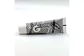 A white and grey tube of Reefs RC gear grease lies horizontally against a plain white background.