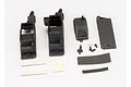 Traxxas receiver box set components including black plastic housing parts, cover, foam tape strips, screws, and hardware laid out on a white background.