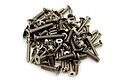 A pile of various metal RC screws with socket heads shown against a plain white background.