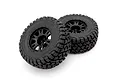 Two black RC monster truck tyres mounted on black multi-spoke rims against a clean white background.