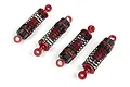 Set of four red and black RC shock absorbers arranged diagonally on a plain white background.