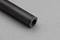 Close-up view of the textured end and surface of a Galaxy Carbon fibre tube against a grey background.
