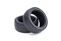 Two black rubber racing slick RC tyres shown angled against a clean white studio background.