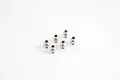 A set of six silver metal pivot balls arranged on a plain white studio background.