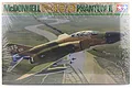 Tamiya 1/32 scale McDonnell Douglas F-4C/D Phantom II plastic model kit box art showing a camouflaged jet flying over a landscape.