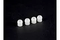 Four small white plastic pivot balls arranged in a row against a dark background.
