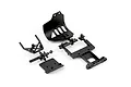 ARRMA black plastic RC car spare parts including a front bumper, rear chassis plate, and mounting components on a white background.