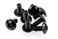 A small pile of black metal button head screws with cross-head drives, commonly used in RC vehicle assembly.