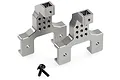 Two gunmetal aluminium RC shock tower mounts with mounting screws on a white background.