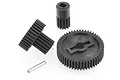 A set of black plastic RC car transmission gears and a small metal pin on a white background.