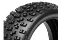 Close-up of a black rubber RC buggy tyre with a blocky tread pattern against a white background.
