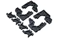 A set of black plastic RC car bulkhead components arranged on a white background.
