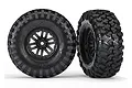 Two Traxxas 1.9-inch Canyon Trail crawler tyres pre-mounted on black multi-spoke wheels, shown from front and side angles.