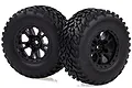 Two black RC off-road wheels with aggressive tread patterns and black multi-spoke rims, shown against a white background.