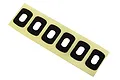 A strip of six black foam adhesive body washers for Traxxas RC cars on a yellow backing sheet.