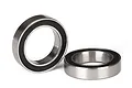 Two Traxxas rubber-shielded ball bearings shown against a white background, one standing upright and one lying flat.