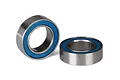 Two metal ball bearings with blue rubber seals sitting on a white background.