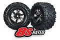 Two Traxxas X-Maxx 8S monster truck wheels with black chrome rims and aggressive all-terrain rubber tires against a white background.