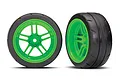 Two Traxxas 1.9 inch Response slick tires pre-glued onto bright green split-spoke RC wheels against a white background.