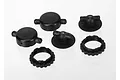 A set of black plastic Traxxas GTR shock caps and spring retainers arranged on a white background.