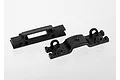 Two black plastic Traxxas shock mount and wire retainer components shown against a white background.