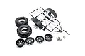 Yeah Racing 1/10 scale dirt bike trailer kit including a black metal frame, two off-road tires, four black wheels, and various assembly hardware.