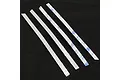 Four long, thin stainless steel diamond plate strips for an RC crawler, two showing the textured metal side and two showing the 3M adhesive backing.