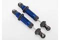 Two blue anodized aluminium Traxxas GTS shock absorbers for RC cars, shown against a plain white background.
