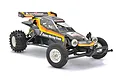 Tamiya The Hornet 2004 1/10 scale RC buggy, a black off-road vehicle with yellow and orange racing stripes, white wheels, and knobby rear tires.
