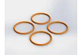 Four orange rubber O-rings arranged in a diamond pattern against a plain white background.