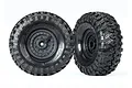 Two Traxxas 1.9 inch Canyon Trail crawler tires pre-mounted on black tactical wheels against a white background.