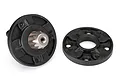 Two black plastic planetary gear housing halves for a Traxxas UDR RC car, one featuring a central metal gear shaft.