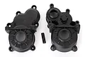 Two black plastic Traxxas E-Revo VXL 2.0 centre gearbox halves and a small metal pin on a white background.