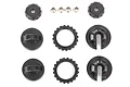 A set of black plastic Traxxas shock caps, spring retainers, and small metal bushings arranged on a white background.