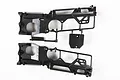 Two black plastic chassis halves for a Tamiya Wild Willy RC model, shown on a white background.