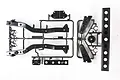 A Tamiya plastic parts sprue for the Wild Willy RC model, featuring black chassis rails and bumper components on a white background.