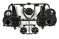 A black plastic Tamiya gear box case parts tree, including two main gearbox halves and smaller circular components, on a white background.