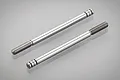 Two Tamiya metal shock shafts for RC cars, featuring threaded ends and grooved piston attachment points, shown against a light grey background.