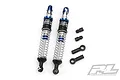 Two Pro-Line Pro-Spec aluminium threaded RC shock absorbers with blue and silver components, plus four small black plastic mounting accessories.