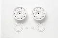 Two white Tamiya 1/14 scale RC truck rims with matching hub covers and spacers on a white background.