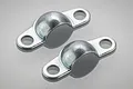Two Tamiya Hornet metal shock mount brackets shown on a light grey background.