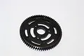 A black GPM Racing 67T steel spur gear for RC vehicles, featuring a lightweight design with cutouts, isolated on a white background.