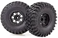 Two black 2.2 inch RC crawler wheels with aggressive off-road tread patterns and black plastic rims, isolated on a white background.