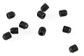 A collection of nine small black metal grub screws scattered on a white background.