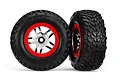 Two Traxxas 2.2/3.0 inch off-road tires pre-mounted on satin chrome and red wheels against a white background.