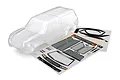 A clear, unpainted Traxxas TRX-4 Sport camper body shell shown with its included decal sheet on a white background.