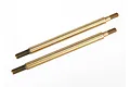 Two gold-colored titanium nitride coated shock shafts for Traxxas RC vehicles, shown against a plain white background.