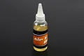 A clear plastic squeeze bottle of Rovan air filter oil with a white nozzle cap against a dark grey background.