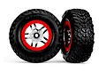 Two Traxxas 2.2/3.0 inch off-road RC tires pre-mounted on satin chrome and red beadlock-style wheels against a white background.
