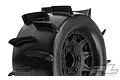 A close-up of a Pro-Line Sand Paw paddle tyre mounted on a black Raid rim for RC monster trucks.